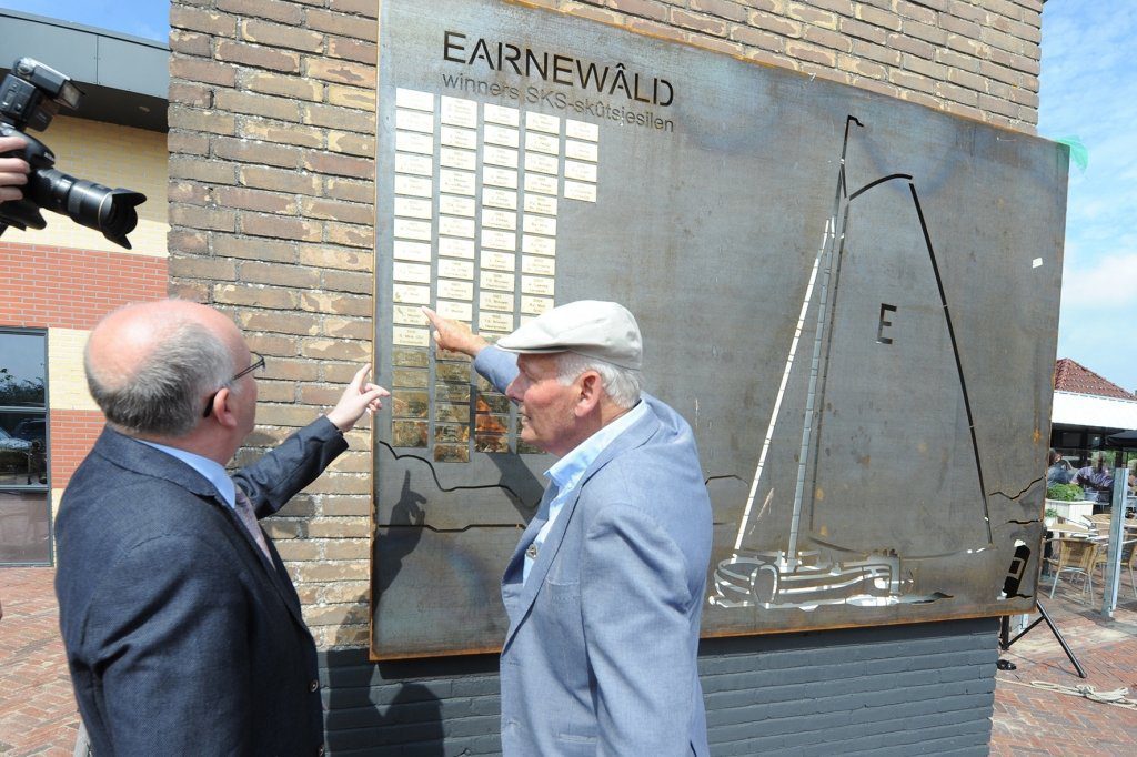 Joop Mink sr. wijst naar de bordjes met daarop zijn heit Berend als winnaar